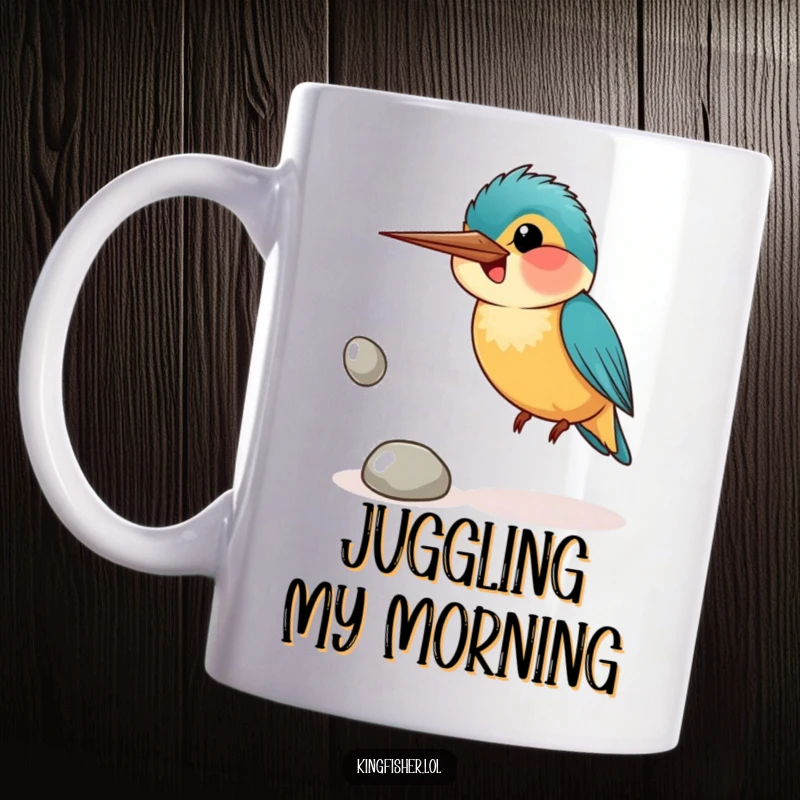 Funny mug with a smiling kingfisher bird awkwardly attempting to juggle three shiny pebbles with a look of earnest concentration.