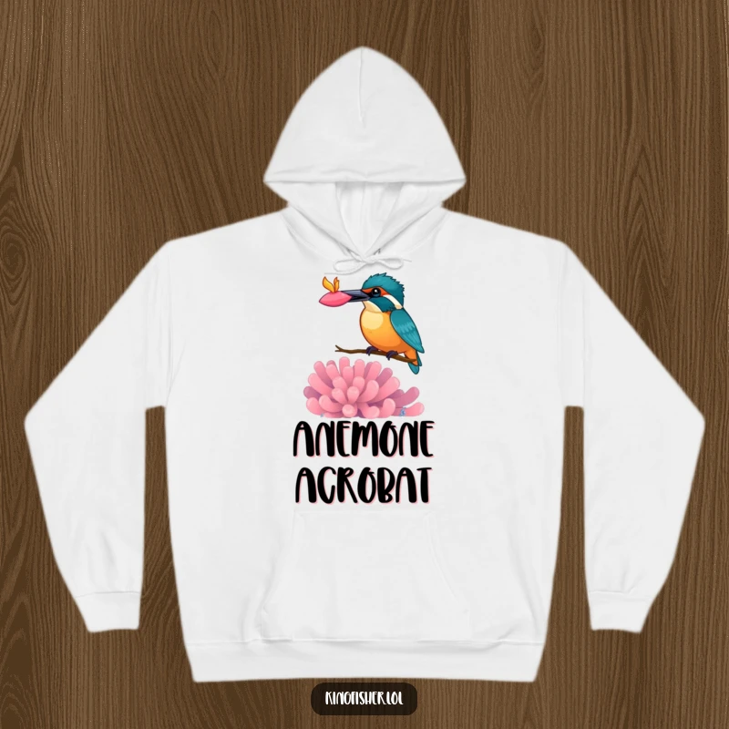 Funny kingfisher hoodie, bird balancing a colorful anemone on its beak, soft and warm apparel, whimsical design.