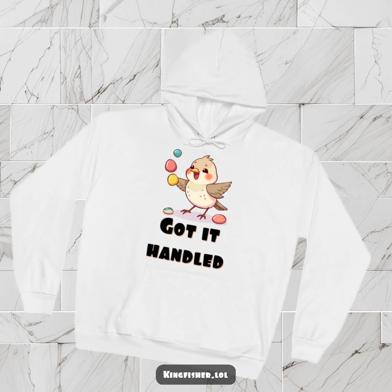 Juggling Bird Hoodie: A small bird expertly juggles colorful pebbles with its beak, embodying playful skill.