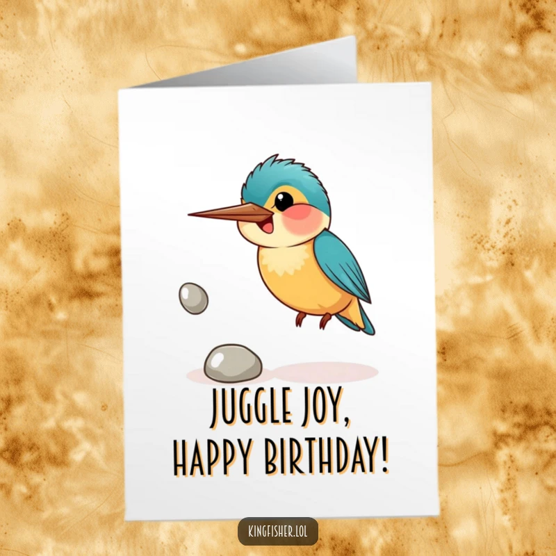 Funny Free Printable Birthday Card: Kingfisher bird awkwardly juggling three shiny pebbles with a wide, goofy smile.