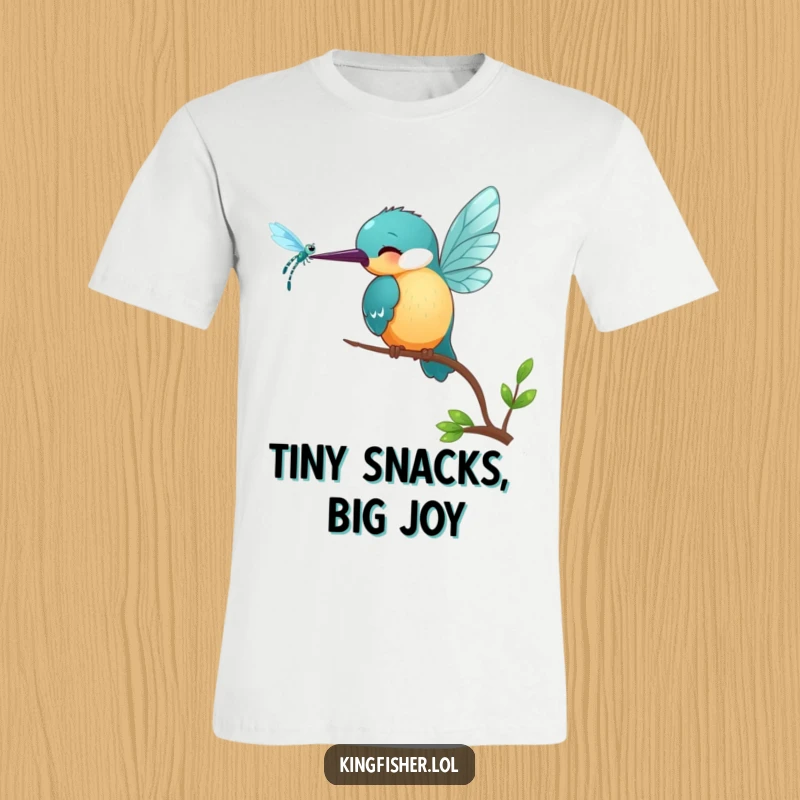 Funny Kingfisher T-Shirt: A small, smiling kingfisher bird pecks playfully at a shimmering dragonfly in a humorous design.