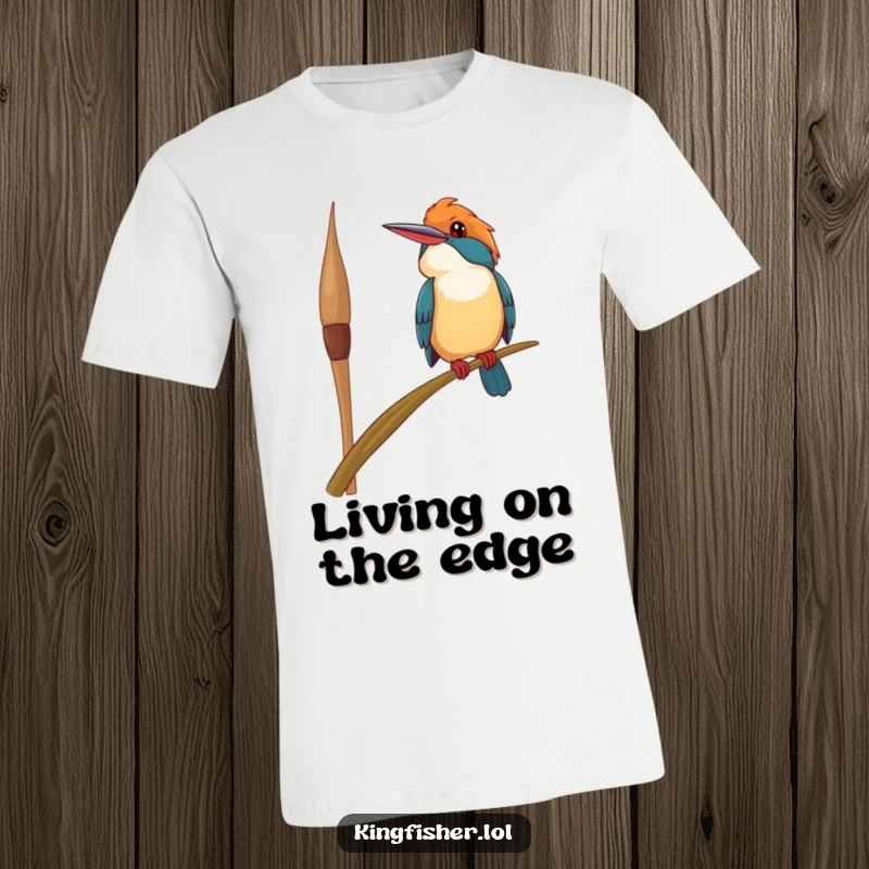 Funny happy kingfisher bird t-shirt, precariously perched on a swaying reed, looking upwards with a smile, conveying joyful optimism.