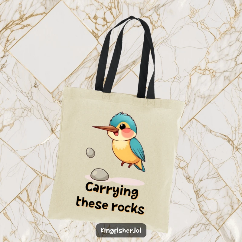 Funny tote bag depicting a smiling kingfisher bird awkwardly juggling shiny pebbles, ideal for carrying daily items with charm.